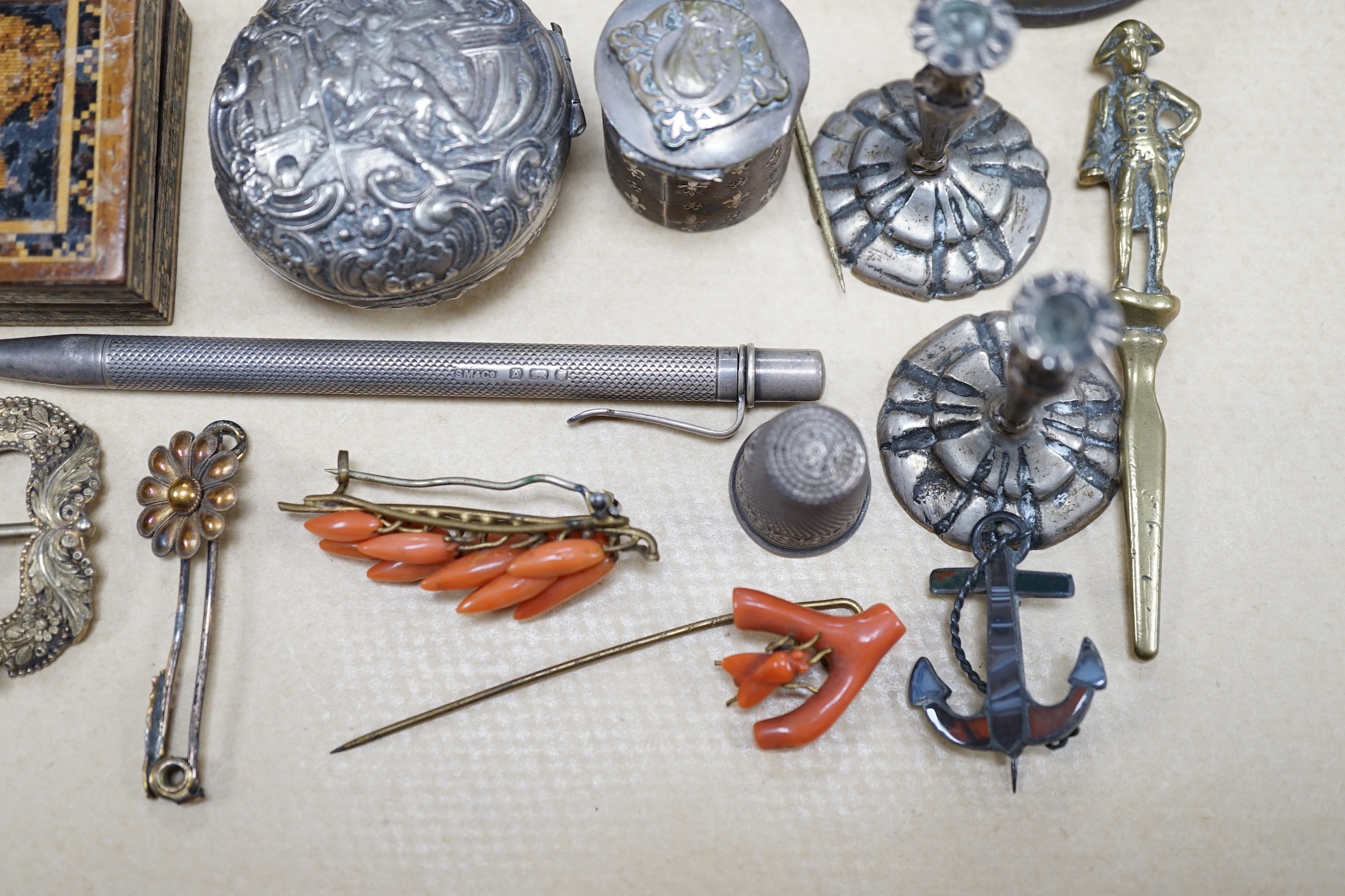 Objects of vertu and jewellery to include a carved coral stick, a pair of miniature candlesticks, a gilt metal shoe buckle, a Scottish hardstone anchor brooch and a Tunbridge ware stamp case. Condition - varies